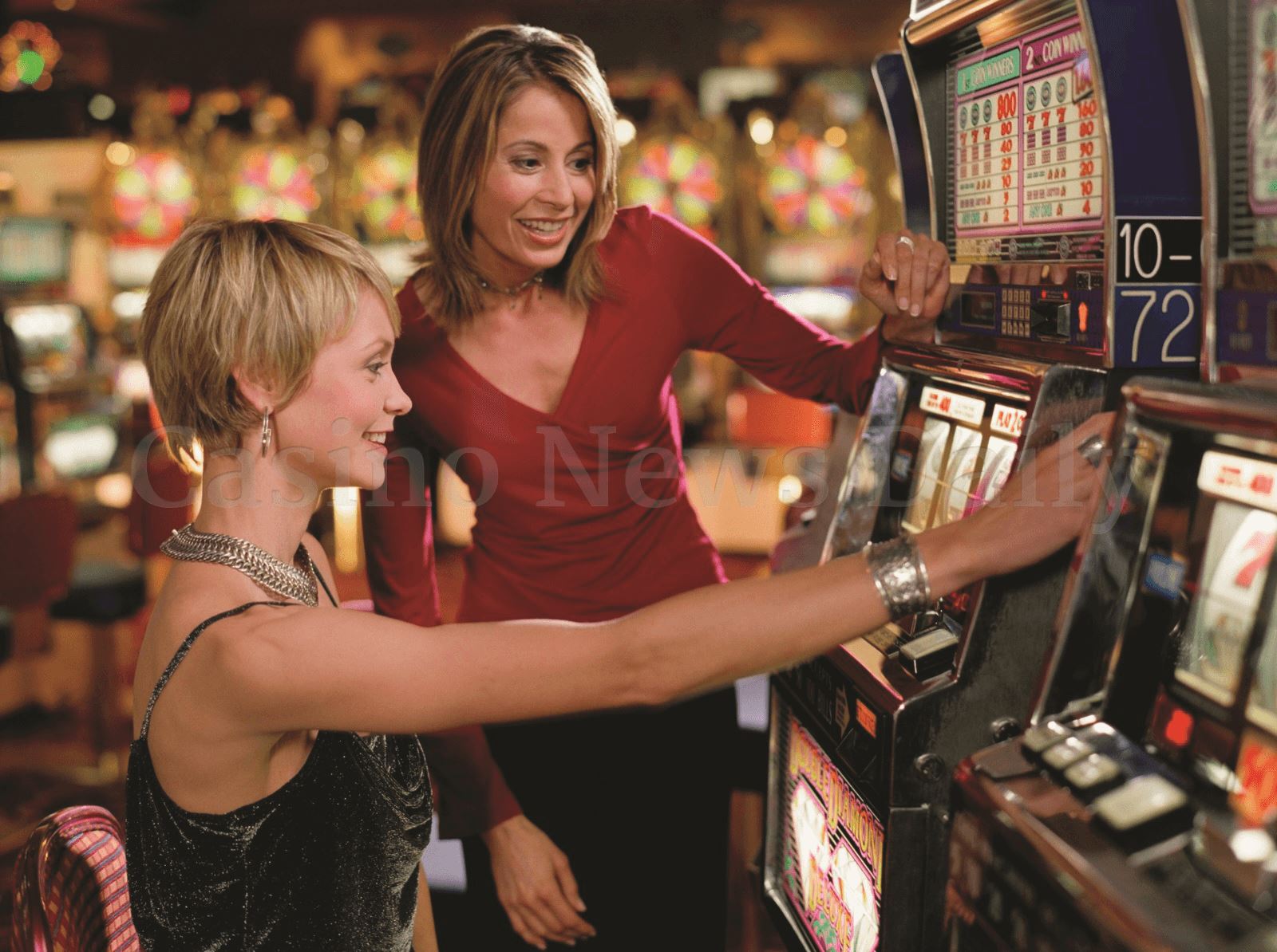 Photo of girls playing slot games in a casino